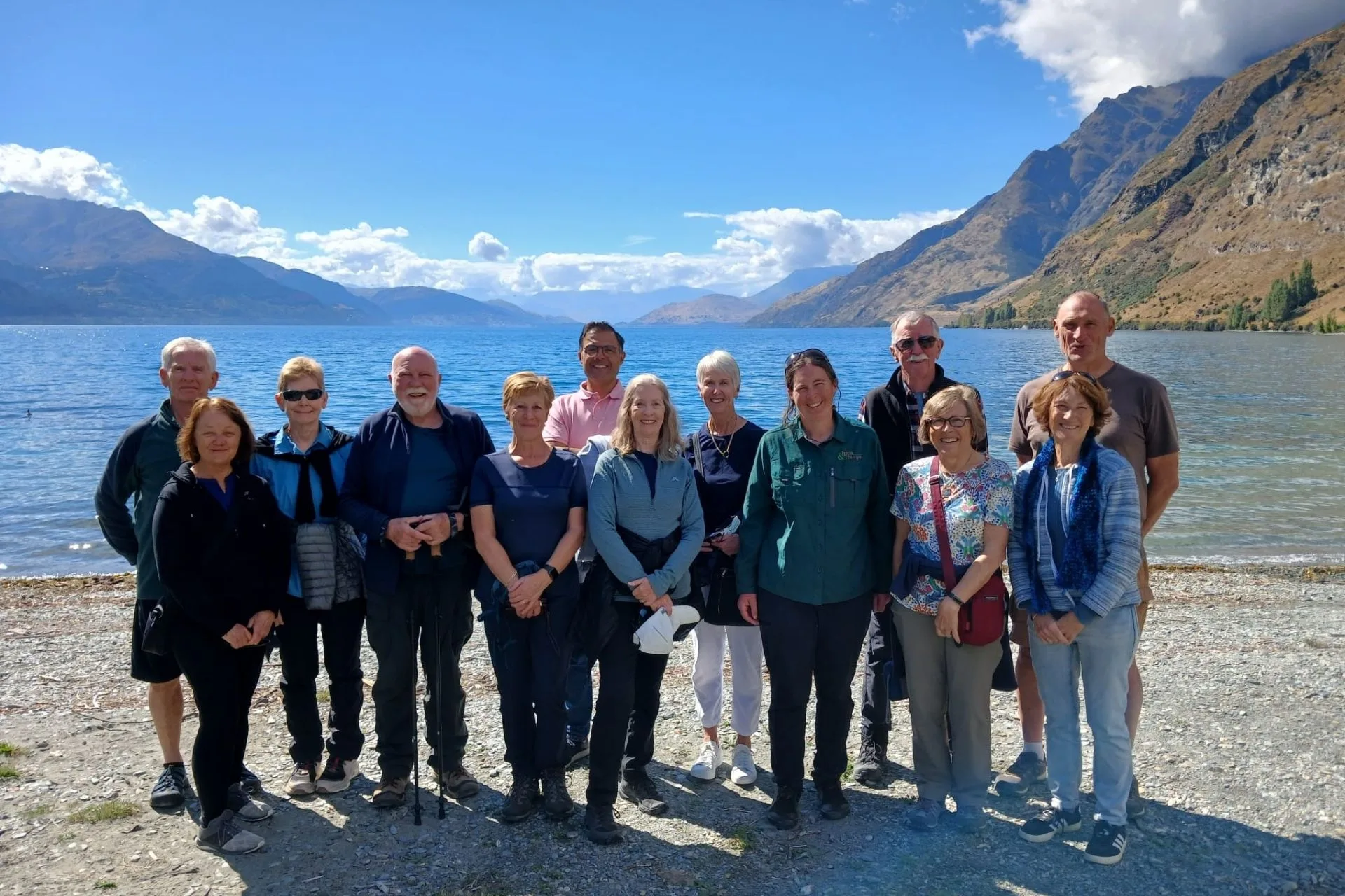 A group of walkers together beside a lake