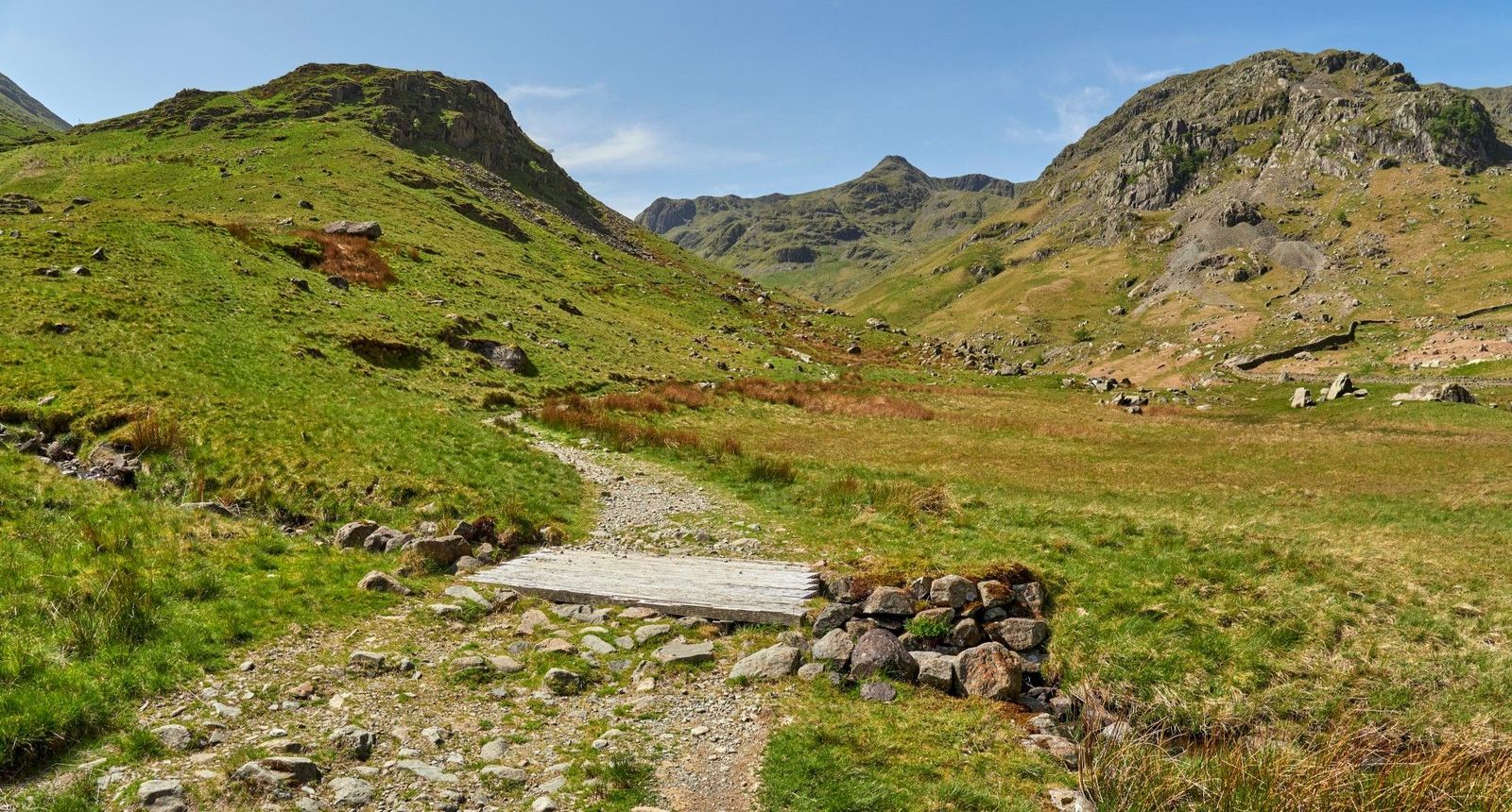 Footbridge along a rocky hiking trail in Grisedale Valley in the Lake District National Park