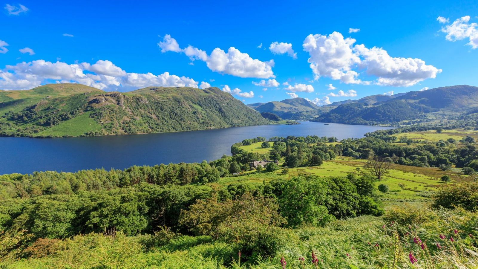 High-angle panorama of the deep blue waters of Ullswater Lake