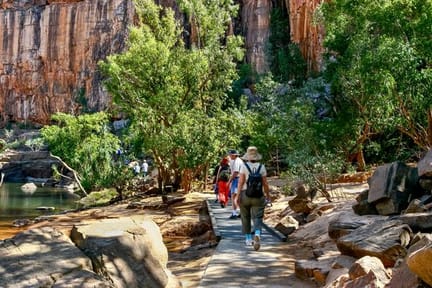 Group of hikers walking along a paved boardwalk in Katherine Gorge