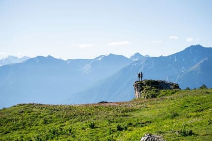 Hikers on a lush green meadow along the Wildstrubel circuit trail in the Valais region of Switzerland-supplied by Eurotrek