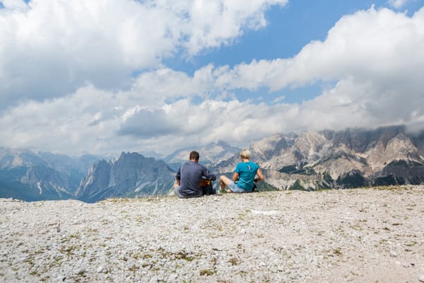 Two Hikers take a break at Mt Helm Elmo Versciaco Sesto Dolomites