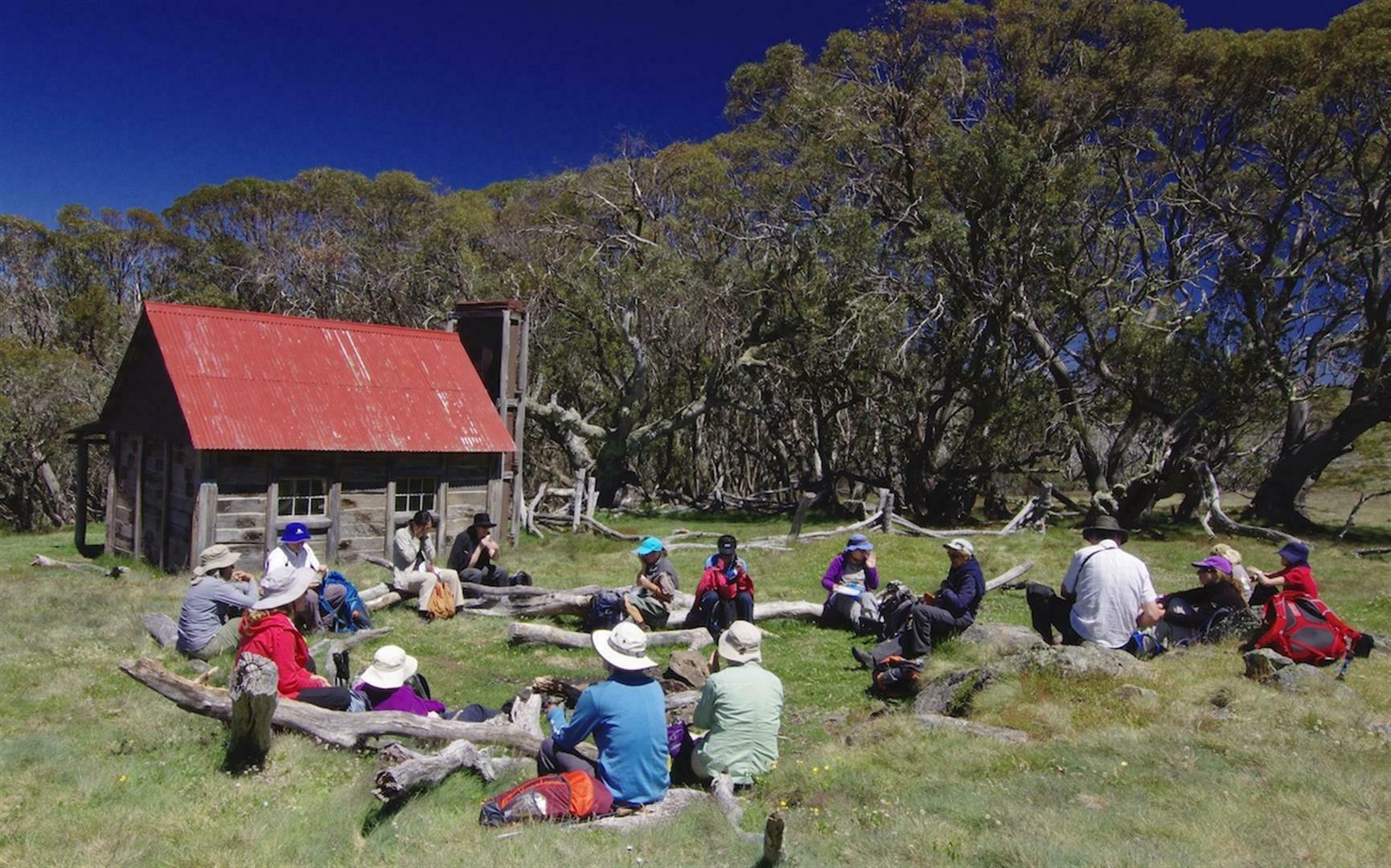 walkers having lunch at hut on the Great Alpine Walk